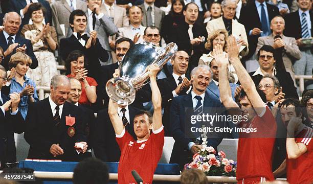Nottingham Forest captain John McGovern lifts the trophy as team mates Larry Lloyd and Frank Clark look on after the 1979 European Cup Final between...