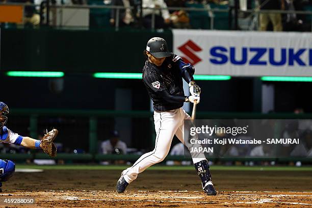 Kenta Imamiya of Samurai Japan hits a RBI single in the top half of the second inning during the exhibition game between Samurai Japan and MLB All...