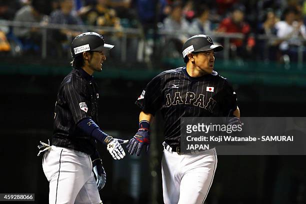 Seiichi Uchikawa of Samurai Japan celerates after scoring in the top half of the second inning during the exhibition game between Samurai Japan and...
