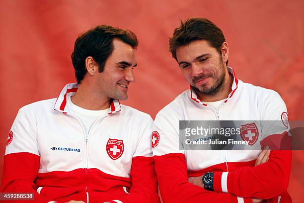 Roger Federer of Switzerland talks with Stanislas Wawrinka of Switzerland at the draw during previews for the Davis Cup Tennis Final between France...
