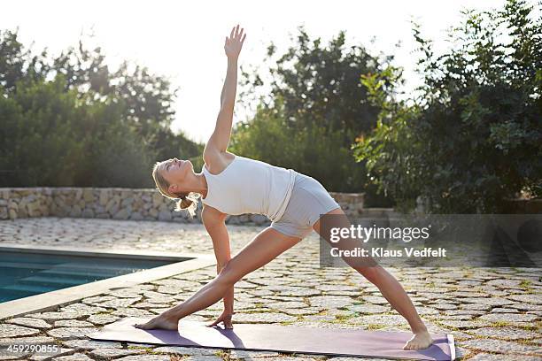 parivrtta trikonasana (revolved triangle pose) - parivrtta trikonasana stock pictures, royalty-free photos & images