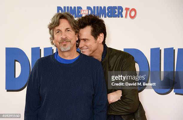 Director Peter Farrelly and actor Jim Carrey attend a photocall for "Dumb and Dumber To" on November 20, 2014 in London, England.
