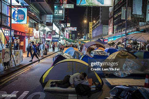 Pro-democracy protester sleeps in the tent at the Mongkok occupy site on November 20, 2014 in Hong Kong. In a random poll of 513 people conducted by...