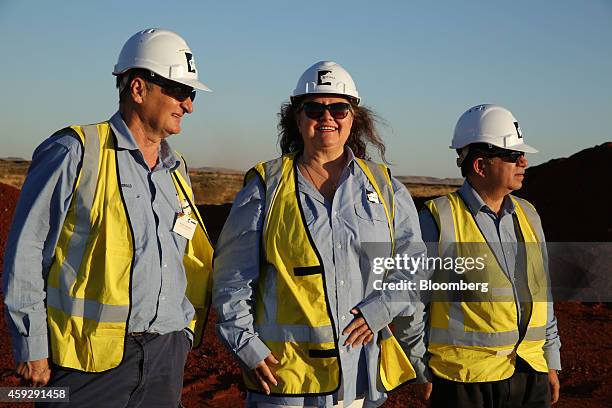 Billionaire Gina Rinehart, chairman of Hancock Prospecting Ltd., center, stands with Barry Fitzgerald, chief executive officer of Roy Hill Mine,...