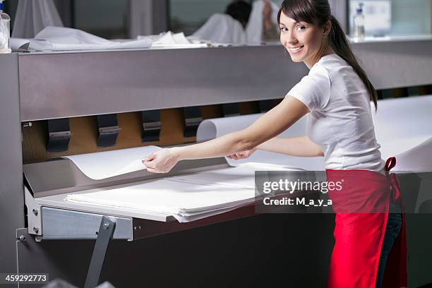 a smiley woman working at a laundry and ironing service - washing mashine stock pictures, royalty-free photos & images