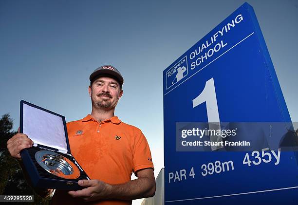 Mikko Korhonen of Finland holds the winners trophy after winning The European Tour qualifying school final stage at PGA Catalunya Resort on November...