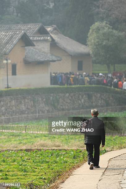 An elderly man walks toward to the former residence of the former Chinese leader Mao Zedong in Shaoshan, in China's central province of Hunan on...