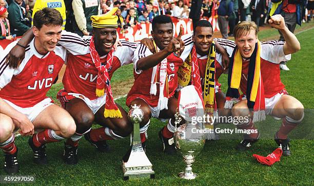 Arsenal players from left to right, Andy Linighan, Kevin Campbell, Paul Davis, David Rocastle and Lee Dixon celebrate after securing the League...