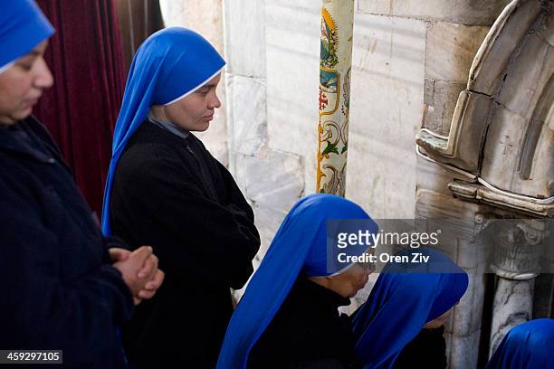 Christian nuns enter the Grotto at the Church of the Nativity on December 25, 2013 in Bethlehem, West Bank. Every Christmas pilgrims travel to the...