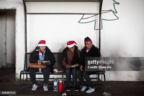 Christian worshippers sit in a parking lot near the Church of the Nativity on December 25, 2013 in Bethlehem, West Bank. Every Christmas pilgrims...