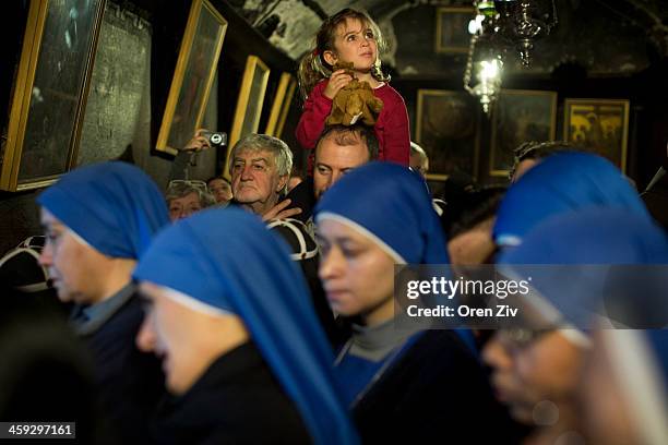 Christian nuns and worshipers pray at the Grotto at the Church of the Nativity, traditionally believed to be the birthplace of Jesus Christ, on...