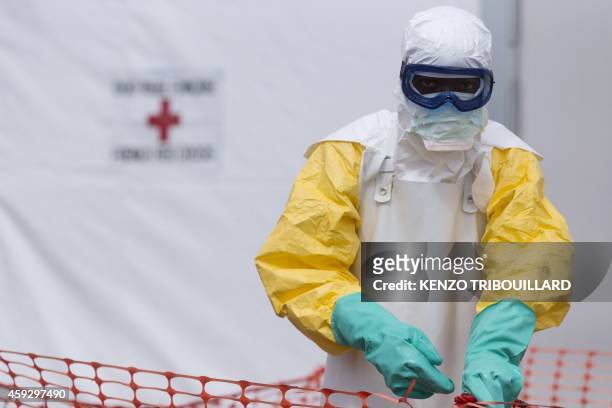 Health worker wearing a personal protective equipment works at the Ebola treatment center run by the French red cross society in Macenta in Guinea on...
