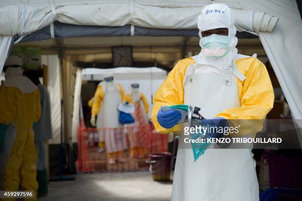 Health worker wearing a personal protective equipment works at the Ebola treatment center run by the French red cross society in Macenta in Guinea on...