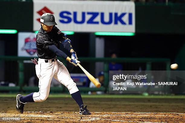 Ryosuke Kikuchi of Samurai Japan hits an one-run double in the top half of the eighth inning during the exhibition game between Samurai Japan and MLB...