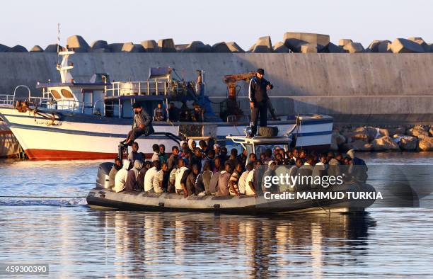 Sub-Saharan African migrants are rescued by the Libyan coastguard after their inflatable boat started to sink off the coastal town of Guarabouli, 60...