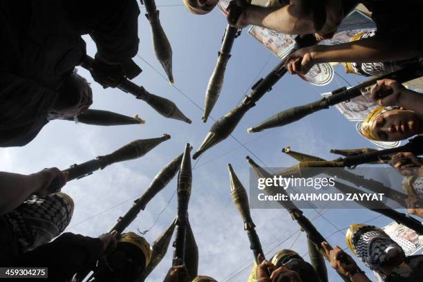 Palestinian Fatah movement fighters parade during a rally marking the 46th anniversary of the secular movement's creation in the refugee camp of Ain...