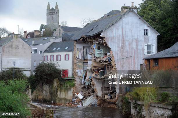 This picture taken on December 25, 2013 shows the facade of an house which collapsed due to floods after the Dirk storm in Quimperle, western of...