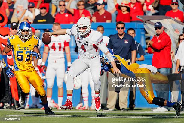 Quarterback Derek Carr of the Fresno State Bulldogs eludes a tackle by linebacker Keith Smith of the San Jose State Spartans as he scrambles for six...