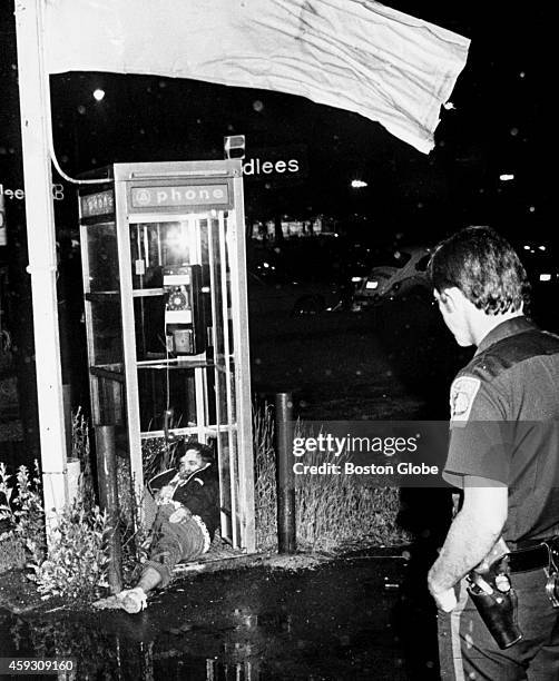 The fatal shooting of Eddie Connors, of Savin Hill, Dorchester, lies in phone booth on Morrissey Boulevard after being slain by shotguns.