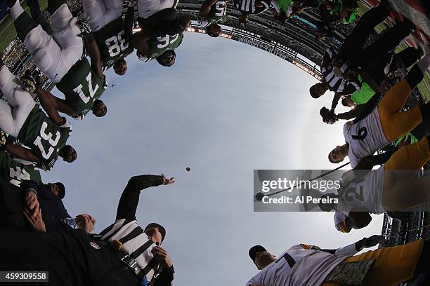 Referee Terry McAulay presides over the coin toss with the captains of the Pittsburgh Steelers and the New York Jets at MetLife Stadium on November...