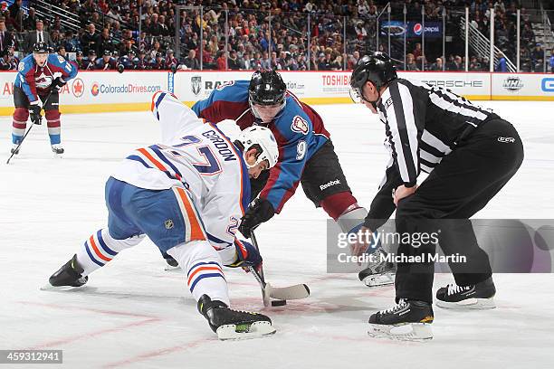 Matt Duchene of the Colorado Avalanche faces off Anton Belov of the Edmonton Oilers at the Pepsi Center on December 19, 2013 in Denver, Colorado.