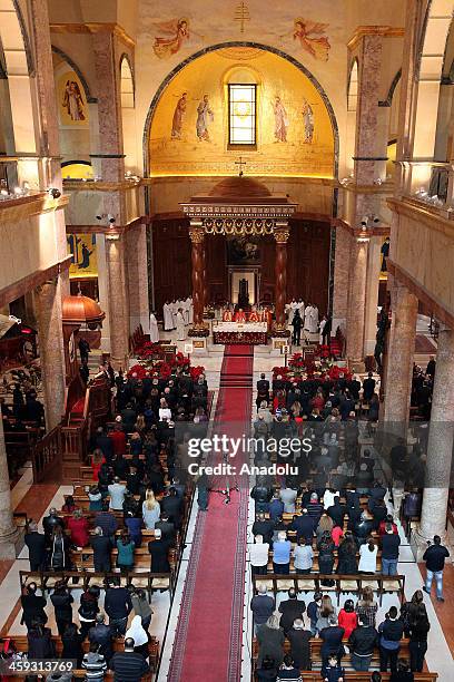Christians attend prayers during a Christmas mass at the Saint George Maronite Cathedral the capital Beirut, Lebanon on December 25, 2013. Christians...
