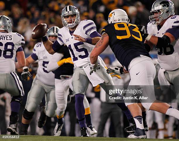 Jake Waters of the Kansas State Wildcats throws a 7 yard touchdown pass in the first quarter against the West Virginia Mountaineers during the game...