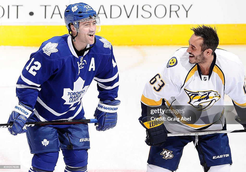 Toronto Predators Stephane Robidas of the Toronto Maple Leafs jokes with Mike Ribeiro ...
