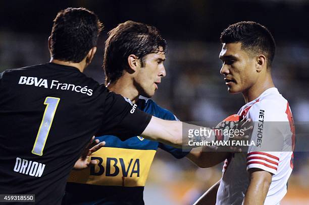 Boca Juniors' goalkeeper Agustin Orion and Juan Forlin try to calm River Plate's forward Teofilo Gutierrez down, during the Sudamericana Cup...