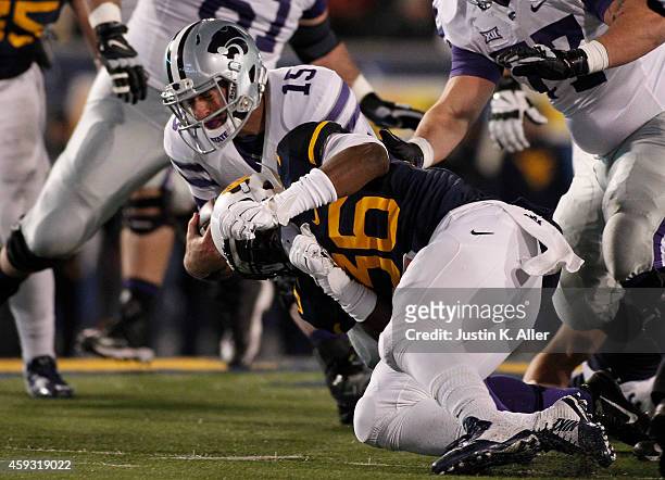 Shaq Petteway of the West Virginia Mountaineers tackles Jake Waters of the Kansas State Wildcats in the second quarter during the game on November...