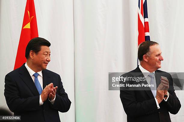 New Zealand Prime Minister John Key and President Xi Jinping attend a ceremony at the Karaka Bloodstock yards on November 21, 2014 in Auckland, New...