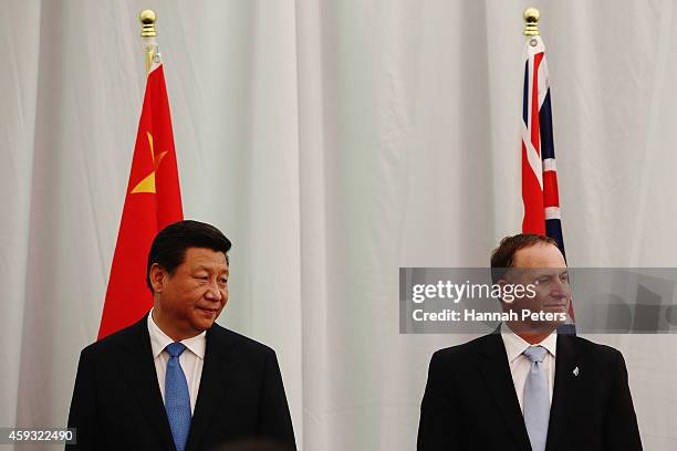 New Zealand Prime Minister John Key and President Xi Jinping attend a ceremony at the Karaka Bloodstock yards on November 21, 2014 in Auckland, New...