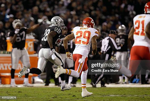 Latavius Murray of the Oakland Raiders runs the ball for a touchdown as Eric Berry of the Kansas City Chiefs pursues in the second quarter of the...