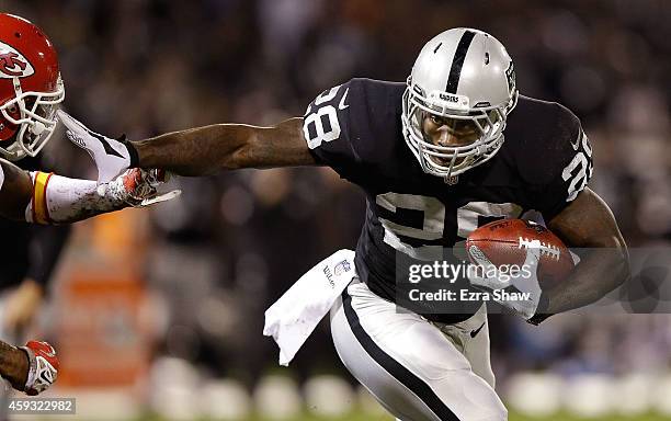 Latavius Murray of the Oakland Raiders stiff arms Sean Smith of the Kansas City Chiefs during the game at O.co Coliseum on November 20, 2014 in...