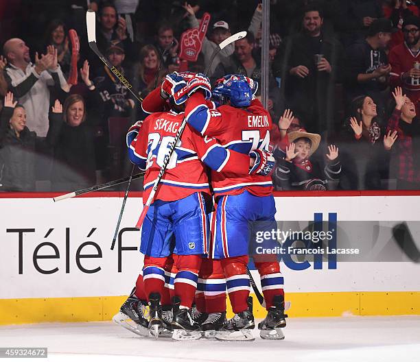 Lars Eller of the Montreal Canadiens celebrates with teammates after scoring a goal against the St Louis Blues in the NHL game at the Bell Centre on...