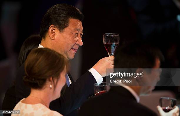 New Zealand Prime Minister's wife Bronagh Key and Chinese President Xi Jinping raise their wine glass during a luncheon at SkyCity Grand Hotel on...