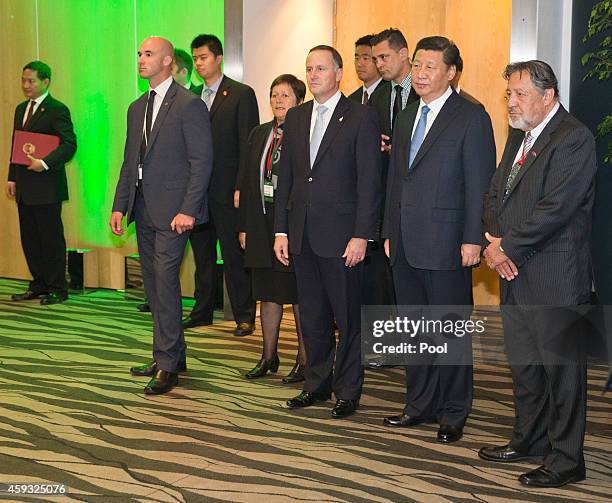 New Zealand Prime Minister John Key, Chinese President Xi Jinping and Pita Sharples Minister of Maori Affairs watch a Maori welcome before a luncheon...
