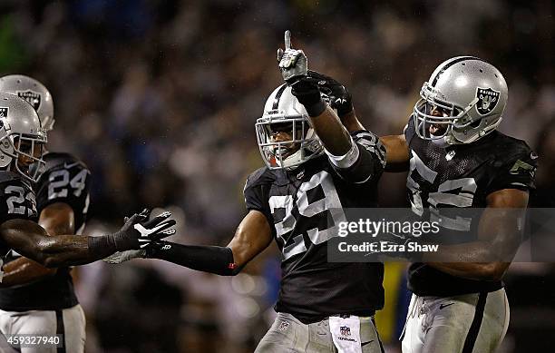 Brandian Ross of the Oakland Raiders celebrates with teammates Tarell Brown and Khalil Mack during the game against the Kansas City Chiefs at O.co...