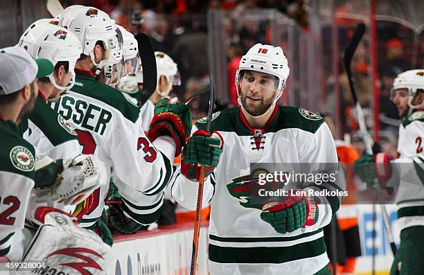 Jason Zucker of the Minnesota Wild celebrates his third period game-winning goal against the Philadelphia Flyers with his bench on November 20, 2014...