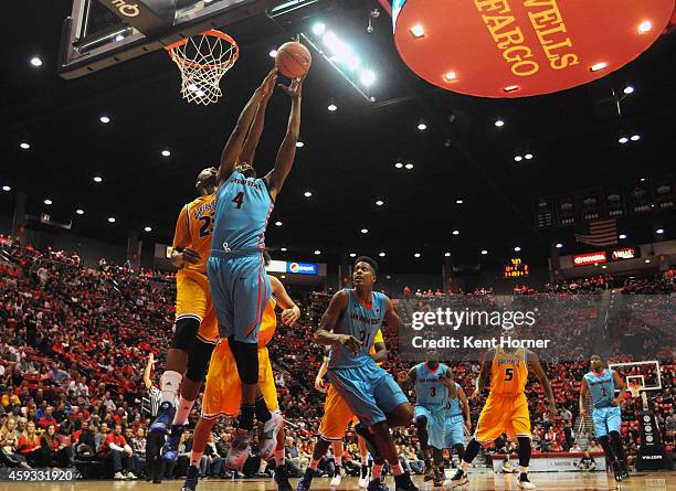 Dakarai Allen of the San Diego State Aztecs rebounds the ball in the first half of the game against Abdul Ahmed of the CSU Bakersfield Roadrunners at...