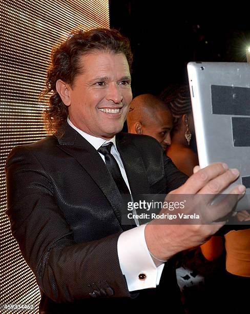 Recording artist Carlos Vives poses for a selfie photo backstage at the 15th annual Latin GRAMMY Awards at the MGM Grand Garden Arena on November 20,...