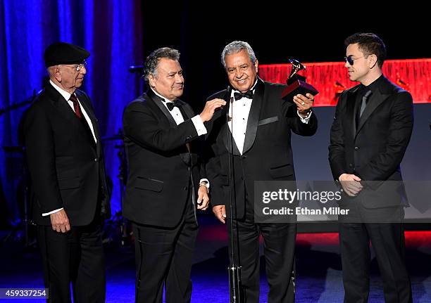 Members of the group La Sonora Santanera accept the award for Best Traditional Tropical Album during the 15th annual Latin GRAMMY Awards premiere...