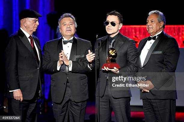 Members of the group La Sonora Santanera accept the award for Best Traditional Tropical Album during the 15th annual Latin GRAMMY Awards premiere...