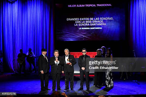 Members of the group La Sonora Santanera accept the award for Best Traditional Tropical Album during the 15th annual Latin GRAMMY Awards premiere...