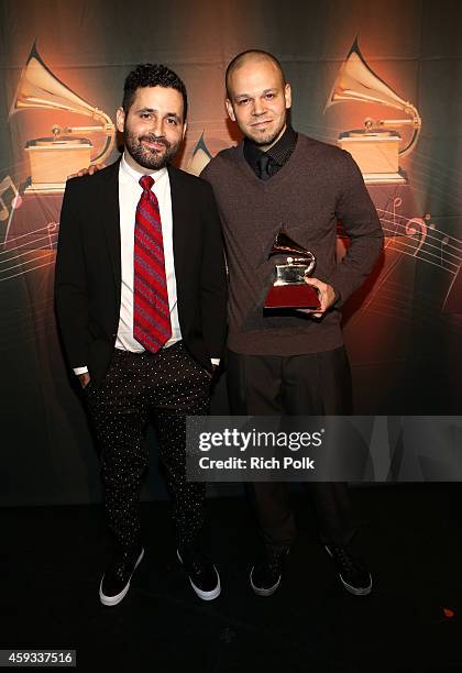 Recording artists Visitante and Residente of music group Calle 13 pose with the Best Alternative Song Award during the 15th annual Latin GRAMMY...