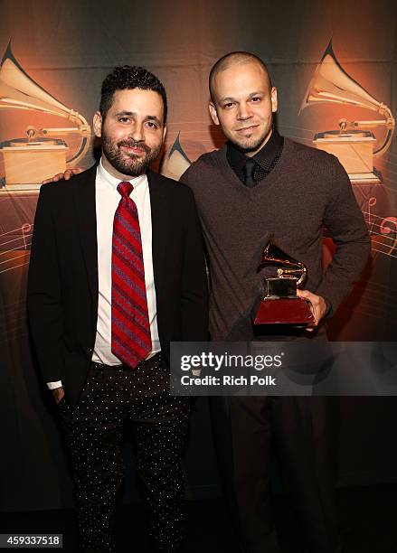 Recording artists Visitante and Residente of music group Calle 13 pose with the Best Alternative Song Award during the 15th annual Latin GRAMMY...