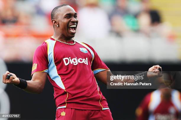 Dwayne Bravo of the West Indies celebrates the wicket of Brendon McCullum of New Zealand during the first One Day International match between New...