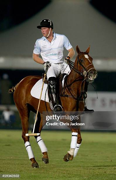Prince Harry plays during the Sentebale Polo Cup presented by Royal Salute World Polo at Ghantoot Polo Club on November 20, 2014 in Abu Dhabi, United...