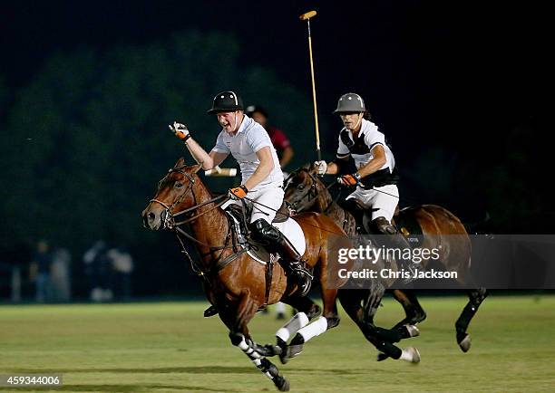 Prince Harry and Nacho Figueras play during the Sentebale Polo Cup presented by Royal Salute World Polo at Ghantoot Polo Club on November 20, 2014 in...