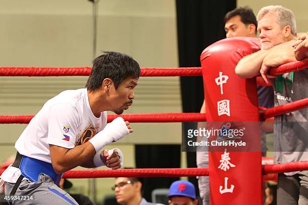 Manny Pacquiao trains while trainer Freddie Roach looks on during a workout session at The Venetianon November 21, 2014 in Macau, Macau.